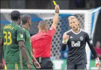  ?? CP PHOTO ?? Vancouver Whitecaps goalkeeper David Ousted (1) voices his objection to the referee as he receives a yellow card during the second half of MLS soccer action against the Portland Timbers in Vancouver on July, 23.