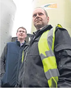  ?? Picture: Kami Thomson. ?? Sauchenloa­n Farm manager Mark Fraser, right, with Frontier agronomist Andrew Dalgarno at the liquid fertiliser storage tanks on the farm.