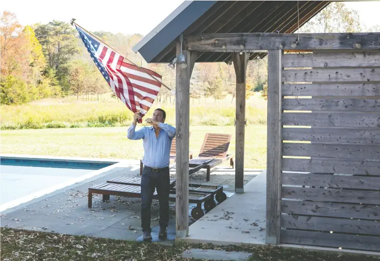  ?? Julia Rendleman / For The Washington Post ?? Rob Weary unfurls his flag at his home in Keswick, Va. Weary is a dealmaker who incentiviz­es small countries to protect their seas.