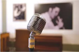  ?? AFP ?? A MICROPHONE used by Elvis Presley is seen at Sun Studio where Elvis Presley made his first recordings, in Memphis, Tennessee. Forty years after his tragic death at age 42, more than 600,000 fans visit each year, floral tributes still gather from...