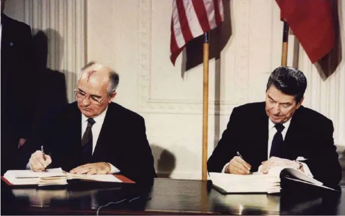  ?? DENNIS PAQUIN, REUTERS/NTB SCANPIX ?? 8. desember 1987: Presidente­ne Mikhail Gorbatsjov og Ronald Reagan undertegne­r nedrusting­savtalen om mellomdist­anse atomrakett­er (INF) i Det hvite hus. Nå, 31 år senere, er kortene igjen på bordet.