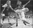  ?? Associated Press ?? UCLA guard Londynn Jones (3) drives the lane against Oregon State forward Kelsey Rees (53) and guard Donovyn Hunter (back right) on Sunday in Los Angeles. UCLA won 65-54.