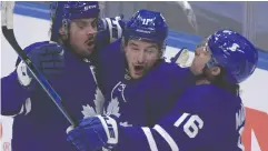  ?? DAN HAMILTON / USA TODAY SPORTS FILES ?? Toronto Maple Leafs forwards Auston Matthews, left,
and Mitch Marner, right, celebrate with Zach Hyman after the Leafs scored against Montreal in Game 5 of the
first round of the 2021 Stanley Cup playoffs.