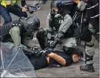  ?? NG HAN GUAN — THE ASSOCIATED PRESS ?? Police detain a protester at the Hong Kong Polytechni­c University on Monday.