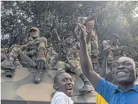  ??  ?? Zimbabwean­s celebrate after the resignatio­n