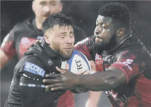  ?? PICTURE: ANDY BUCHANAN/AFP ?? 0 Warriors’ Ali Price finds his progress halted by Lyon’s Kevin Yameogo at rain-soaked Scotstoun