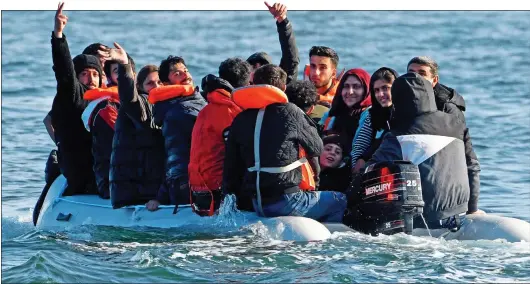  ??  ?? A TRAGEDY WAITING TO HAPPEN: This small boat packed with migrants was filmed in the English Channel by Nigel Farage last week