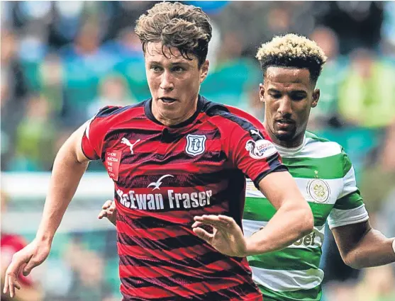  ?? Picture: SNS. ?? Defender Jack Hendry, pictured going up against Celtic’s Scott Sinclair, has another year left on his Dens Park contract.