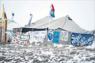  ?? Mark Boster Los Angeles Times ?? A PROTEST camp near the Dakota Access pipeline last month. Standing Rock Sioux Tribe leaders have urged the demonstrat­ors to abandon the camps, fearing a police crackdown and expected springtime f looding.
