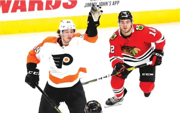  ?? CHARLES REX ARBOGAST/AP ?? Flyers forward Joel Farabee snags the puck out of the air as Alex DeBrincat closes in on him in the second period Thursday night at the United Center.