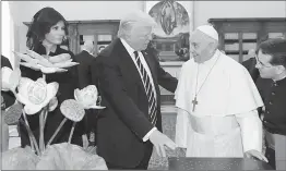  ?? AFP ?? Pope Francis exchanges gifts with US President Donald Trump and US First Lady Melania Trump during a private audience at the Vatican on Wednesday.