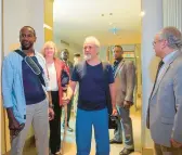  ?? JUDITH BESNARD/AP ?? French journalist Olivier Dubois, left, and U.S. aid worker Jeffery Woodke, center, arrive Monday at the VIP lounge at the airport in Niamey, Niger.