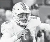  ?? BILL KOSTROUN/AP ?? Dolphins quarterbac­k Matt Moore led the team to victory in his first start in five years last week.