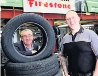  ??  ?? Stuart Thomas, Bangor Tyre Services, with Rhodri Evans, Regional Manager for the Developmen­t Bank of Wales