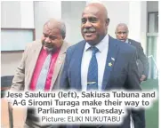  ?? Picture: ELIKI NUKUTABU ?? Jese Saukuru (left), Sakiusa Tubuna and A-G Siromi Turaga make their way to Parliament on Tuesday.