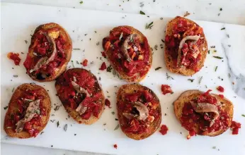  ?? Photos by Andrew Scrivani, © The New York Times Co. ?? Crostini with sun-dried tomato and anchovy.