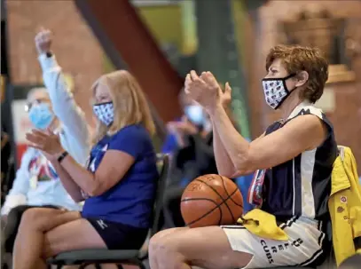  ?? Pam Panchak/Post-Gazette ?? Paula Franetti, right, a Senior Olympian in basketball, applauds the announceme­nt Wednesday at the Senator John Heinz History Center in the Strip District that the biennial 2023 National Senior Games will be played in Pittsburgh.