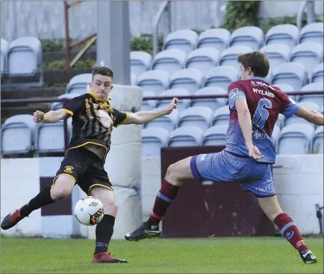  ??  ?? Jake Hyland stretches in an attempt to block Dave Curran’s clearance for Cobh Wanderers.