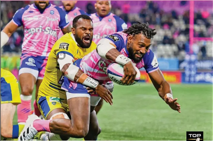  ?? Photo: Top 14 ?? Stade Francais centre Waisea Nyacalevu scores one of his two tries despite Alivereti Raka’s tackle in their 22-14 win over Clermont in the Top 14 clash in Paris, France, on October 11, 2021. Barring an injury Nayacalevu is definite starter for the Flying Fijians in the November Test matches.