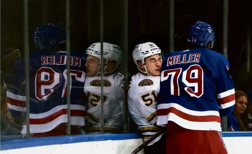  ?? BRUCE BENNETT/GETTY IMAGES ?? The Rangers were the latest team to get physical with Bruins rookie Matt Poitras, as defenseman K’Andre Miller drove him into the boards/glass during the first period.