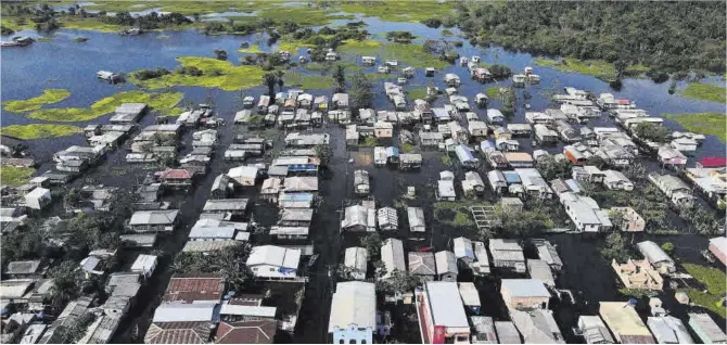  ?? Bruno Kelly / Reuters ?? Vista aèria de les inundacion­s al veïnat de Cacau Pirera, a l’Amazònia brasilera, el 2021.