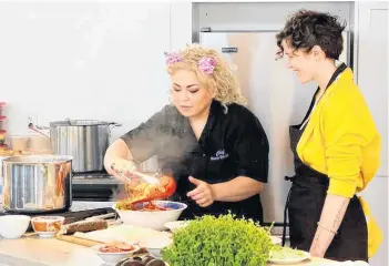  ??  ?? Chef Ilona Daniel demonstrat­es preparing lobster.