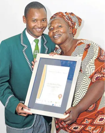  ?? Picture: RANDELL ROSKRUGE ?? TOP ACHIEVER: Avukile Austin Nkayi from Ngcobo’s Nyanga Senior Secondary School, who obtained seven distinctio­ns, with his mother Thembeka.