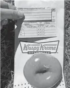  ?? PROVIDED BY DEBBIE NELSON ?? Debbie Nelson, a Denver-area resident, celebrates her first dose of the COVID-19 vaccine by getting a free Krispy Kreme doughnut.