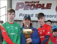  ??  ?? Joint captains Anto Larkin and Lee Jordan accepting the Jim Byrne Cup from James Mullally.