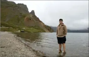  ?? NG HAN GUAN — THE ASSOCIATED PRESS ?? In this Saturday photo, Sinead of Australia stands in the cool water of Lake Chon during a hike arranged by Roger Shepherd of Hike Korea on Mount Paektu in North Korea. Hoping to open up a side of North Korea rarely seen by outsiders, Shepherd, a New Zealander who has extensive experience climbing the mountains of North and South Korea is leading the first group of foreign tourists allowed to trek off road and camp out under the stars on Mount Paektu, a huge volcano that straddles the border that separates China and North Korea.