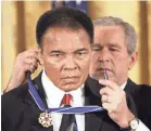  ??  ?? President George W. Bush presents the Presidenti­al Medal of Freedom to Ali in 2005. EVAN VUCCI/AP