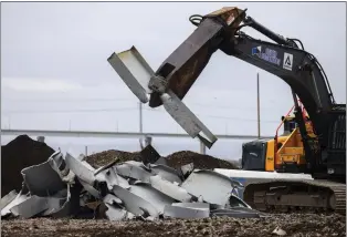  ?? JULIA NIKHINSON - THE ASSOCIATED PRESS ?? A shearer breaks apart salvaged pieces of the collapsed Francis Scott Key Bridge at Tradepoint Atlantic on Friday in Sparrows Point, Md.