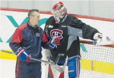  ?? JOHN KENNEY/MONTREAL GAZETTE ?? Montreal Canadiens goalie Mike Condon, speaking with goalie coach Stephane Waite Monday, will be the No. 1 while Carey Price is injured.