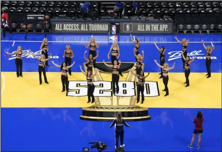  ?? DAVID ZALUBOWSKI — THE ASSOCIATED PRESS ?? Denver Nuggets cheerleade­rs practice on the new floor installed for the league’s in-season tournament before a game between the Nuggets and the Dallas Mavericks on Friday at Ball Arena.