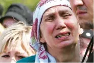  ?? AP PHOTO/DMITRI LOVETSKY ?? A woman cries Wednesday during the funeral of Elvira Ignatieva, an English language teacher who was killed at a school shooting on Tuesday in Kazan, Russia.