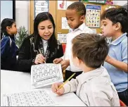  ?? RAY STEWART / CANTON REPOSITORY ?? Teaching assistant Dilia Samadova goes over a math lesson in Jennifer Zenobi’s kindergart­en class at Our Lady of Peace School in Canton.
