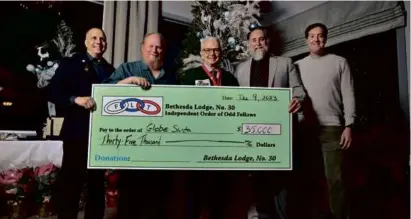  ?? JOSH REYNOLDS FOR THE BOSTON GLOBE ?? Members of the Bethesda Lodge of the Independen­t Order of Odd Fellows (from left) vice grand John Weeks, noble grand James McKnight, president Dave Rupp, and vice president Ken Rupp presented Globe Santa executive director Bill Connolly (center) with $35,000.