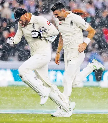  ??  ?? England’s Jonny Bairstow and James Anderson dash for cover as a storm hits Lord’s. Play at the Test was suspended for three hours, but England still managed to dismiss India for 107 with Anderson taking five wickets as the conditions helped the ball swing.