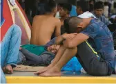  ?? MARCO UGARTE/AP ?? Migrants traveling by foot rest Friday at a sports complex in the town of Mapastepec in Mexico’s Chiapas state. The group hopes to reach the United States.