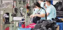  ??  ?? Workers assemble ice-skating shoes at a manufactur­ing factory in the ice and snow sports equipment industry park in Zhangjiako­u in northweste­rn China’s Hebei province Thursday, July 15, 2021. (AP)