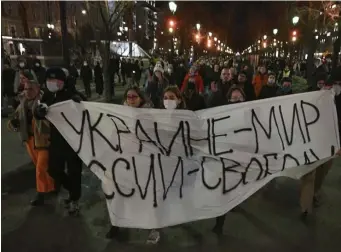  ?? Ap file ?? SPEAKING OUT: Demonstrat­ors march with a banner that reads “Ukraine — Peace, Russia — Freedom” in Moscow in February after Russia’s attack on Ukraine.