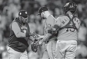  ?? Frank Franklin Ii/associated Press ?? Astros manager Dusty Baker takes the ball from reliever Ryan Pressly during the ninth inning of Thursday’s loss to the Yankees.