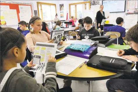  ?? Carol Kaliff / Hearst Connecticu­t Media ?? Teacher Cathy Emerick’s sixth-grade language arts class at the Bethel Middle School is filled with children comprising the biggest grade in the district with 275 students.