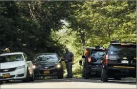  ??  ?? Above and above right, New York State Police block the entrance of Welch Road in Corning, N.Y., Monday as they investigat­e the scene of a shooting in nearby Erwin. A New York state trooper responding to a domestic call early Monday morning was killed along with a suspect, officials said.