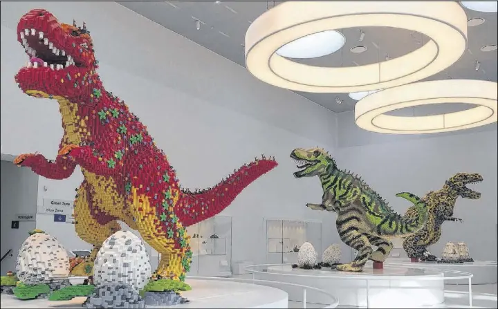  ?? Ap photos ?? Three dinosaurs made entirely of Lego bricks are seen on display inside the new Lego sleepover house. Lego has teamed up with Airbnb, in Billund, Denmark, to offer the chance for a dream sleepover in the house. To be considered, people must enter a...