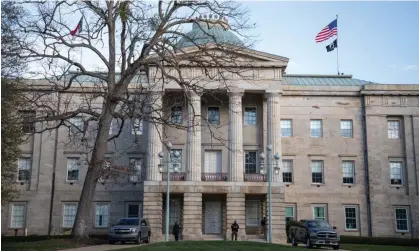  ?? Photograph: Logan Cyrus/AFP/ Getty Images ?? Law enforcemen­t stand guard outside of the state capitol building in downtown Raleigh, North Carolina.