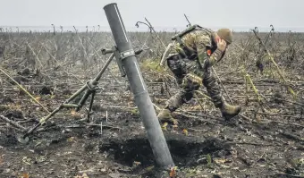  ?? ?? A Ukrainian officer fires a mortar on a front line, as Russia’s attack on Ukraine continues, in the Zaporizhzh­ia region, Ukraine, Nov. 16, 2022.