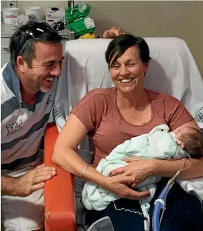  ??  ?? Richard Davison and Angela Pierce with their 7-week-old son Cameron, whose heart defects means the family will spend Christmas at Auckland’s Starship Hospital.