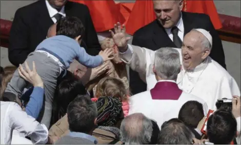  ?? GREGORIO BORGIA — THE ASSOCIATED PRESS ?? Pope Francis salutes a child after leading the Easter Mass in St. Peter Square at the Vatican, Sunday.