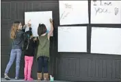  ?? Allen J. Schaben Los Angeles Times ?? KIDS show their support for the 13 Turpin children as they write notes on a poster in Perris.